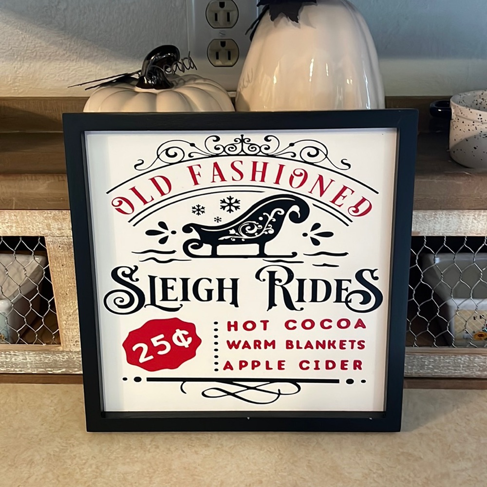 Old-fashioned sleigh rides framed Christmas sign